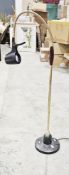 Serious floor standing reading lamp with brass-effect and wooden swan-neck adjustable column,