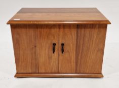 Early 20th century walnut table-top cocktail cabinet having half-hinged lid and two panel doors