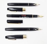 Two Sheaffer fountain pens in black cases with gold-plated trim, each having a 14k gold nib , in a