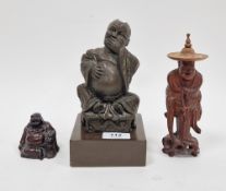 20th century bronzed resin figure of a laughing Buddha, seated on a plinth serpent and brick moulded