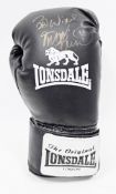 Lonsdale black boxing glove, signed Best Wishes by the boxer Frank Bruno, contained in a clear