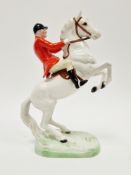 Beswick pottery model of a huntsman on horseback, huntsman seated on a white rearing stallion,