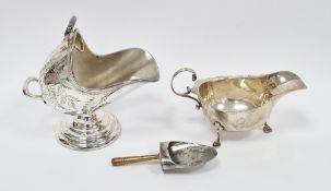 Silver sauce boat by Asprey & Co Limited, London 1934, with wavy rim and scroll handle, on three