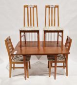 Mid-century teak extending dining room table, the rectangular top pulling out to a concealed leaf,