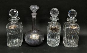 Collection of cut glass decanters, stoppers and silver labels including a pair of square section
