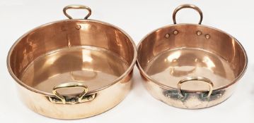 Two 19th century copper preserve pans, one with twin brass loop handles, the other with twin brass