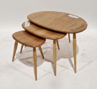 Ercol pale elm and beech nest of three pebble tables model no.354, largest 40cm high x 65cm wide x