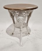 Pub table with circular mahogany top, on a white painted cast iron base, the three legs decorated