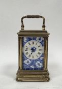 Late 19th century porcelain panelled brass cased carriage clock, the blue and white panels with