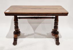 Early Victorian rosewood library table, the rectangular top with rounded corners, carved frieze,