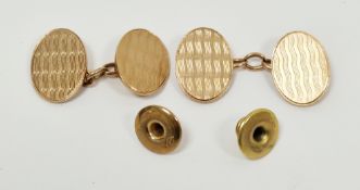Pair of 9ct gold cufflinks, the oval plates with engine-turned decoration and chain links and a pair