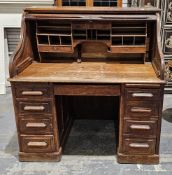 Early 20th century oak rolltop desk, the tambour top opening to an interior fitted with