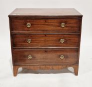 Early 19th century mahogany chest of three long graduated cockbeaded drawers, the top with reeded