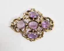 Victorian pinchbeck and amethyst-coloured stone brooch, shaped oval, the five stones set within