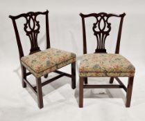 Set of six Chippendale-style mahogany dining chairs having scrolling carved top rails and pierced