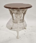 Pub table with circular mahogany top, on a white painted cast iron base, the three legs decorated