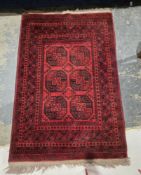Eastern red ground rug with two rows of three elephant foot guls, multiple geometric borders flanked