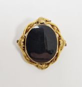 Victorian yellow metal oval swivel mourning brooch, with glazed front and back, within a leafy