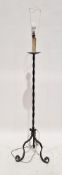 Wrought metal standard lamp having a twisted column on three scrolling legs, with shade, 161cm high