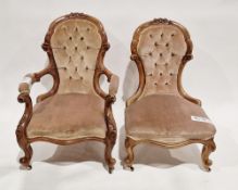 Pair of Victorian walnut his and hers salon armchairs, each with a balloon back, the frames carved
