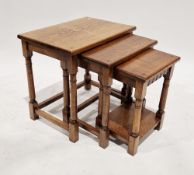 In the manner of Titchmarsh & Goodwin oak nest of three tables on turned tapered and block supports,