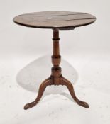 George III oak pedestal table, the circular top on a turned tapered baluster support with three