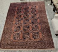 Large Pakistani brown ground wool pile rug with three rows of six elephant foot guls and two rows of
