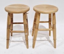 Pair of beechwood modern stools with circular seats, on turned tapering legs, 51cm high x 42cm