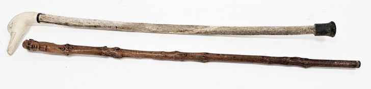 19th century folk art walking stick, the handle carved in the form of a head, 79cm long and