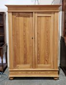 19th continental pine cupboard, the moulded cornice over two panel doors opening to an interior