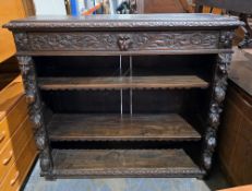 Victorian dark oak dwarf library bookcase, the rectangular top with foliate carved edge, over a long
