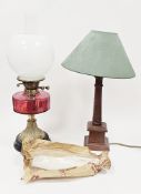 Victorian oil lamp with opaque glass globular shade and cranberry glass well, on a brass base and