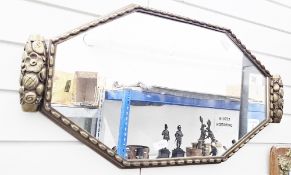 Art Deco brass framed wall mirror, of lozenge form, the frame with flower and chain embossed