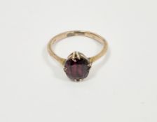 Gold and garnet ring, the cushion cut garnet in four-claw setting, marked 9ct, finger size I, 1.9g
