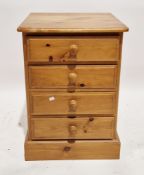 Modern pine chest of four drawers with wooden knob handles, on a plinth base, 77cm high x 54cm