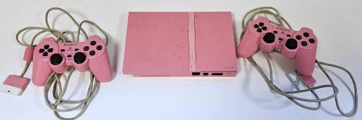 Pink PlayStation 2 with two pink controllers, Buzz controllers and Singstar microphone