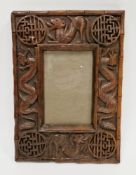 Carved Chinese wooden picture frame, circa 1900, carved with scrolling serpent like beasts and