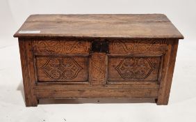 18th century oak coffer, the hinged lid opening to an empty space, the two-panel front with carved