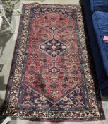 Eastern red/blue ground rug with central geometric medallion on geometric pattern field, geometric