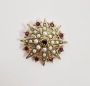 9ct gold, garnet and seedpearl brooch of circular starburst design, the star set with central garnet