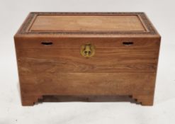 South East Asian camphorwood chest, the hinged lid having a border carved with flowers, opening to a