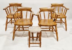 Set of four beechwood captains-style elbow chairs, each with spindle backs, solid seats, on turned