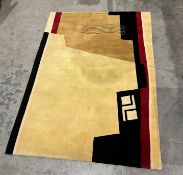 Modern wool pile cream ground rug with red and black geometric pattern, 185cm x 126cm