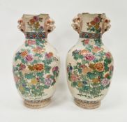 Pair of late 19th century Japanese Satsuma ware vases, oviform with lion dog masks, painted with