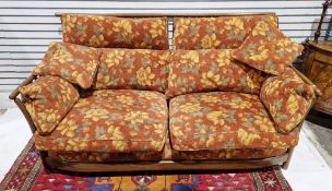Ercol Renaissance ash and elm settee and matching armchair having yellow flowered on a rustic ground