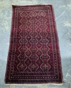 Eastern red ground rug with hooked lozenge trelliswork, multiple geometric borders, 153cm x 88cm