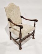 Walnut framed armchair in the Carolean manner, having an upholstered camel back and stuffover