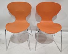 16 stackable cafe bistro chairs in orange with polypropylene shell seats with ribbed backs, on