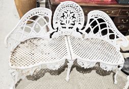 In the manner of Coalbrookdale cast iron garden bench with a white finish, having pierced shaped