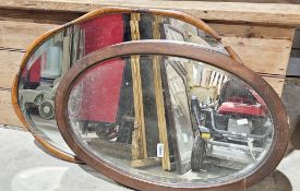 Early 20th century oval bevel edged wall mirror with shaped walnut frame, 75cm x 53cm and another
